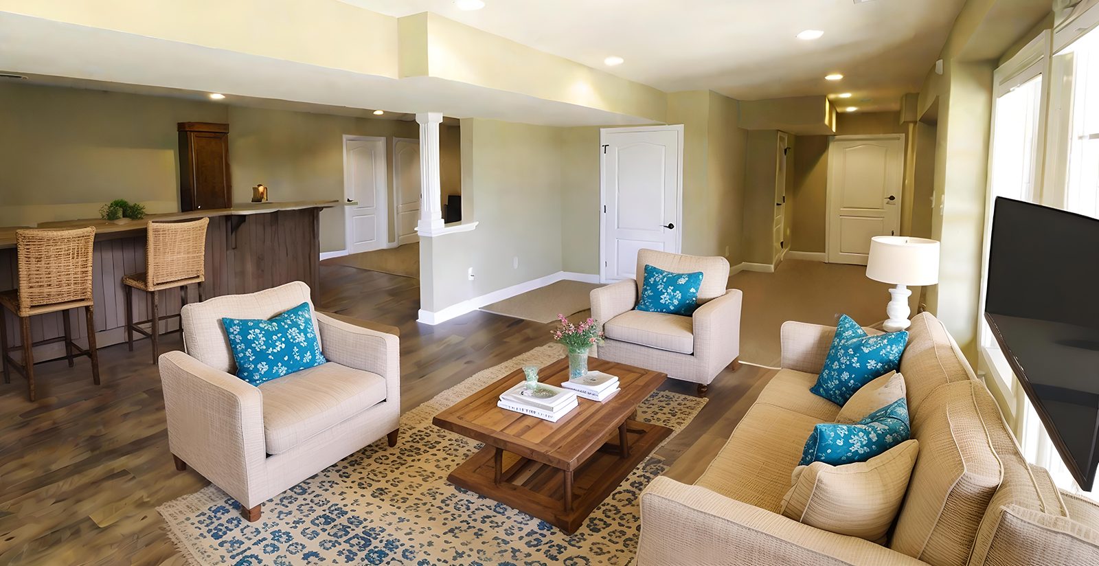 Finished basement living room with seating area and home bar